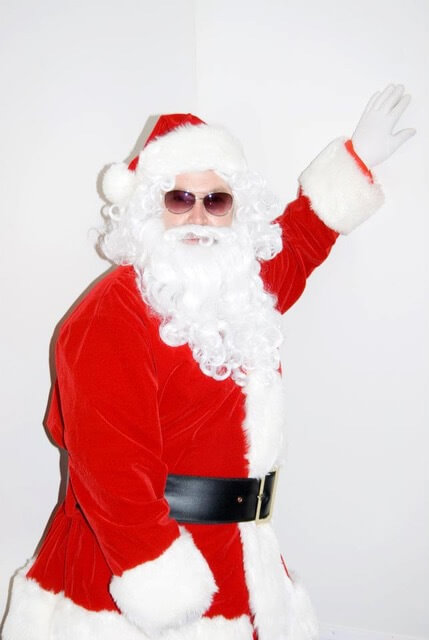 Attorney Jack Edwards dressed as Santa Clause with sun glasses in front of a white background